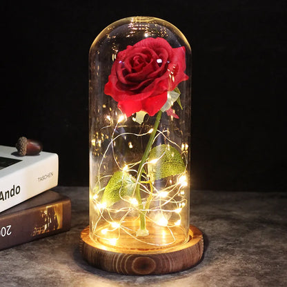 a vase of red roses sitting on a table 