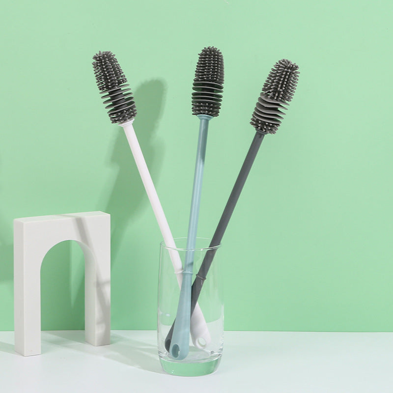 a couple of toothbrushes in a glass vase 